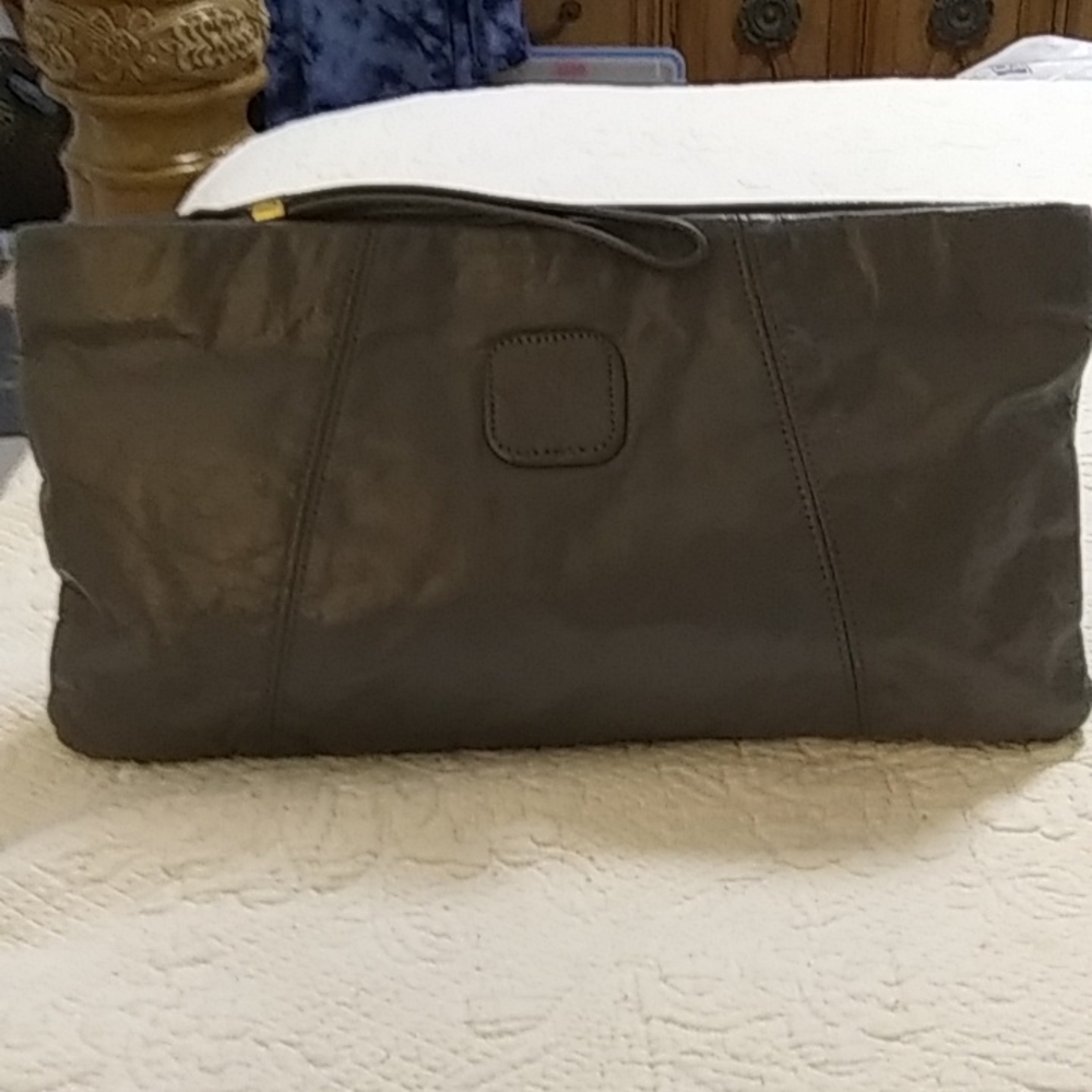 Woman's medium greyleather wristlet /clutch fully lined in Carmel color material